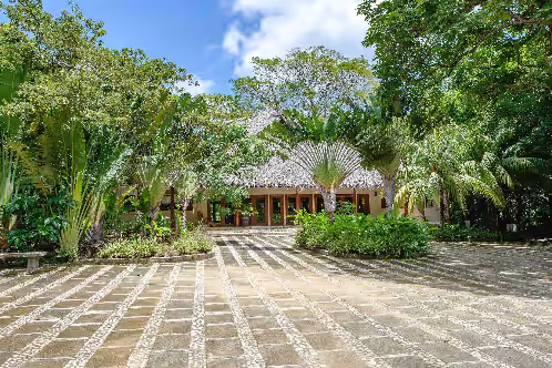 And glows amongst the trees in the day at Private And Gated Beach Front Retreat (Sleeps 16) On Exclusive Playa Majagual