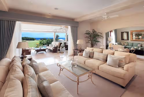 Lounge opens out on to covered terrace at Luxury 6 Bedroom Villa On The Exclusive Royal Westmoreland Resort from £1125