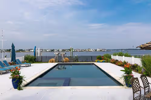 Pool at 2023 home on river, across from Beach. Outdoor kitchen bath pool spa fireplace