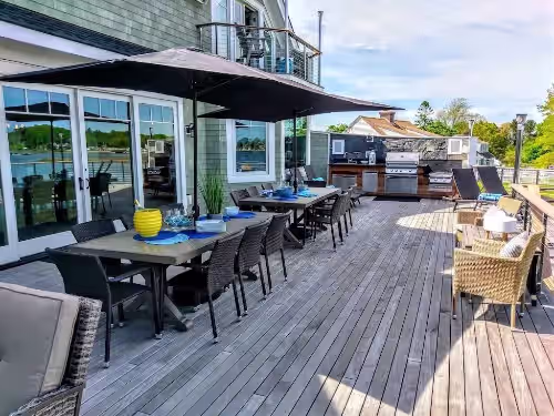 Outdoor dining at Luxury Waterfront Home Sleeps 16 Game Room Private Beach and Dock