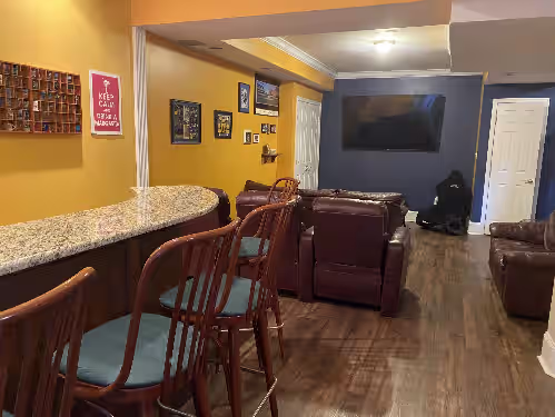 Bar overlooking the theater room with 75 inch TV at 3 acre waterfront estate