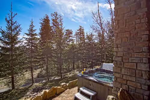 The hot tub is located on the ground level. at Slope side 8 BR at Sanctuary Majestic Mountain Top Estate 4800 square feet of