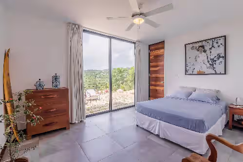 First Floor Guest Bedroom 1, door to private bathroom and sliding doors to patio at Luxury Modern New Build with Incredible