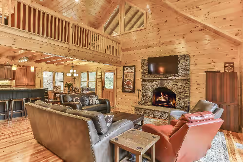 Handcrafted Pine interior open floor plan connects kitchen, dining & living area at Riverside Sanctuary: Serene Luxury Lodge