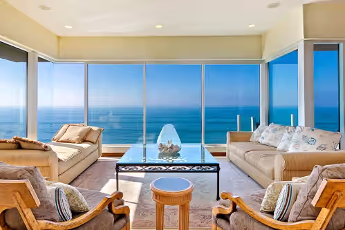 Ocean sunset sitting area off kitchen and dining areas at Oceanfront Beach, Pool, Hot Tub, Pickleball, Movie Theater,
