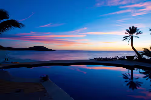 Pool with ocean view during sunset at Rancho de Costa: One-of-a-Kind Beachfront Estate on the Bay of Dreams