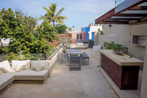 Outdoor dining at Luxe villa within Walled Town in Cartagena, adorned with masterpieces. 12 guests