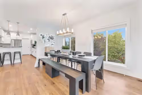 Eat together at the large dining table set for 16 at Mountainside Luxury Entertainer