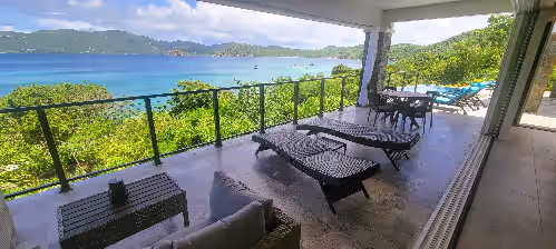 Your patio overlooking the garden path to your very own private beach at BEACHFRONT 5 BEDROOM VILLA–POOL, SOLAR, PRIVATE