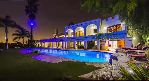 Evening photo pf the pool area. at Impressive Furnished 9 BR/10 BA Entertainment Dream Estate
