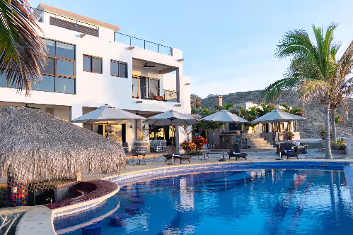 Main pool with Cabo tanning shelf, swim up bar. at "Villa Rocas" Beachfront Luxury Villa