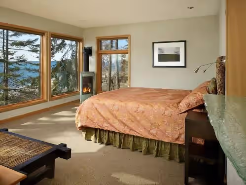 Lovely main bedroom with water view, fine linens, down duvet, gas fireplace. at Whidbey's Finest Luxury Beachfront Compound-