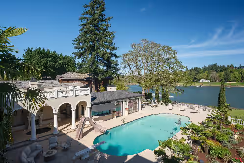 Resort-style outdoor oasis featuring a private pool with slide, spacious patio, and stunning waterfront views. at Palais de