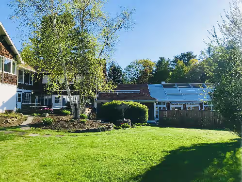 Side view of the house and patio at Private Home with Large Indoor pool- Perfect for Summer Fun, Fall Foliage & Ski