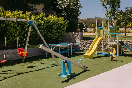 Family fun awaits with a children’s playground designed for joyful play. at Ino Villa, Unique Group Gatherings
