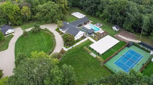 Aerial View of Property with Tennis/Basketball Court & Event Tent at Luxury Estate with 3 Homes, Pool, Hot Tubs,