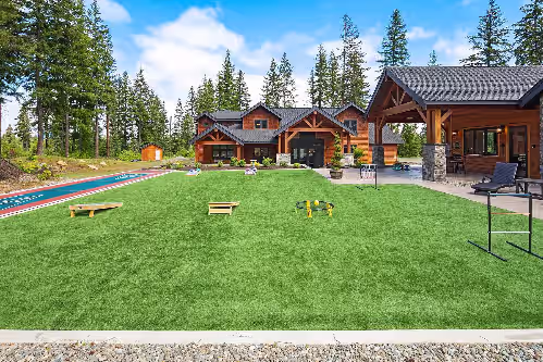 Grand Cascadian: - Lawn shuffleboard and corn hole on artificial turf. The pool house is to the right.