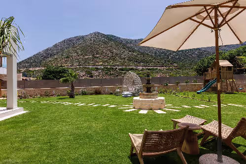 Spacious lawn covered garden at the rear part of the Villa. at Beachfront villa with daily cleaning, sauna & gym: by etouri