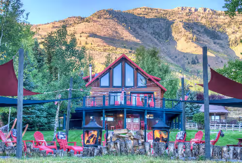 The lodge at sunset. Chopped firewood + outdoor pillows & blankets provided! at Luxury Lakefront Lodge-less than 15mins to